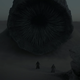 Paul and Lady Jessica standing before a sandworm.